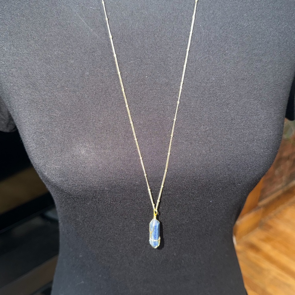 Blue Lapis lazuli crystal point pendant wrapped in gold-tone wire necklace